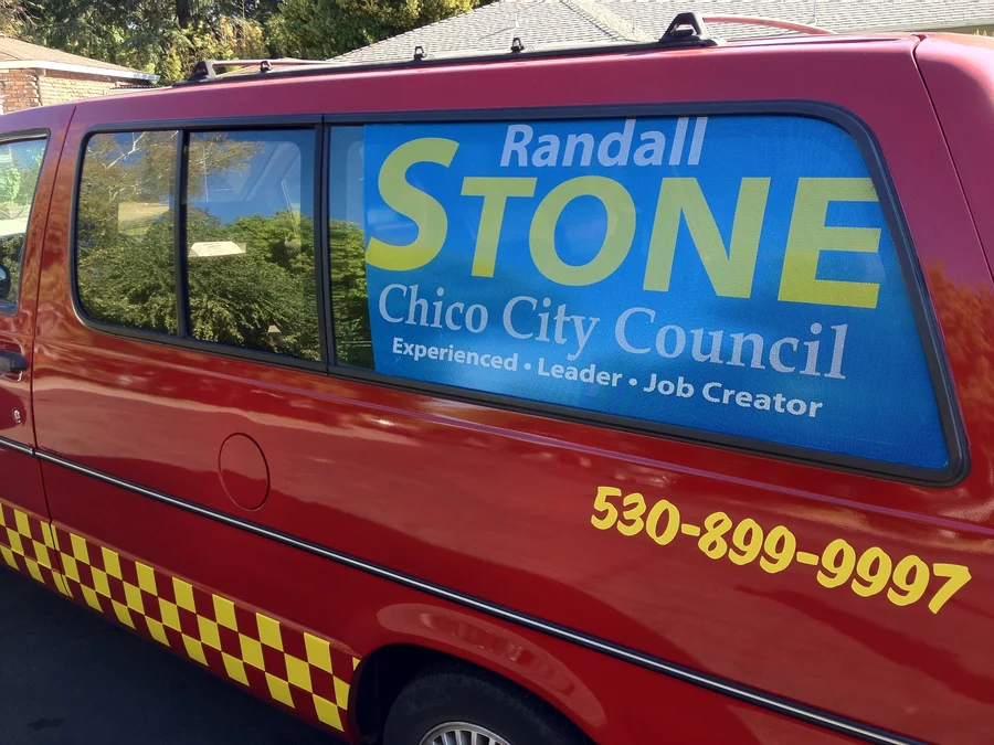 Taxi cab carrying a Randall Stone Council campaign sign