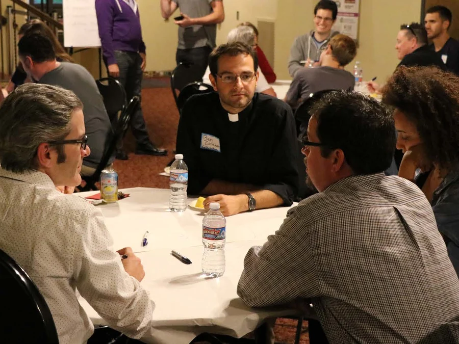 Post-meeting discussion after an LGBTQ+ performance and community event